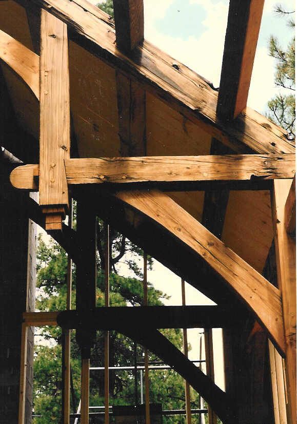 A close up of a wooden structure with trees in the background