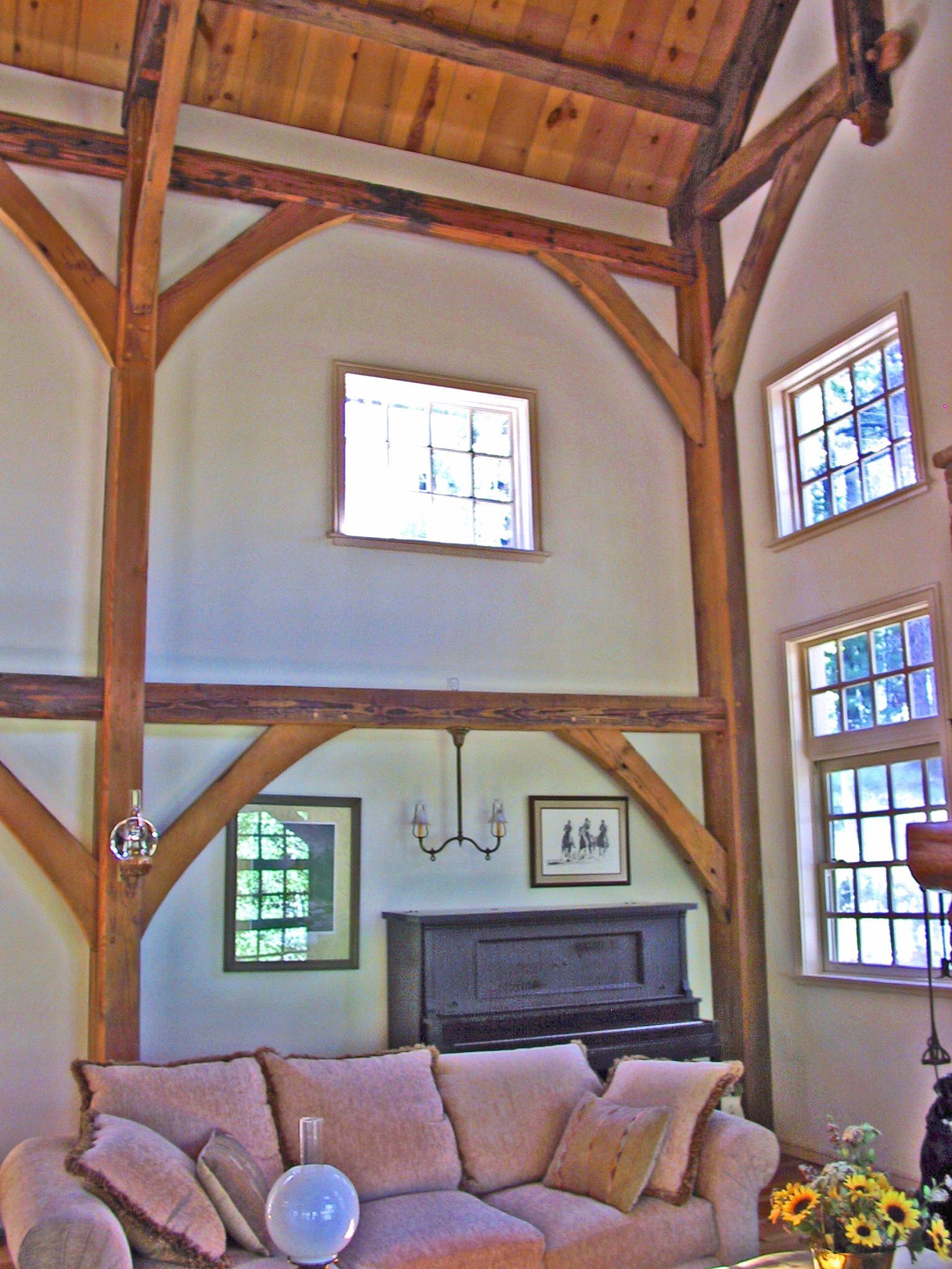 A living room with a couch and a piano