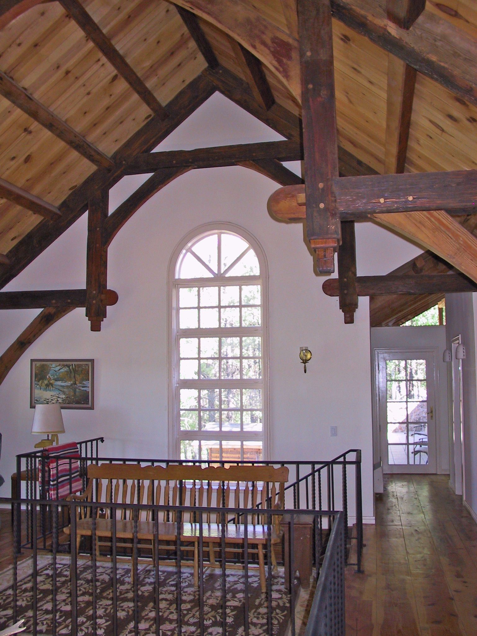 A living room with a wooden ceiling and a large window