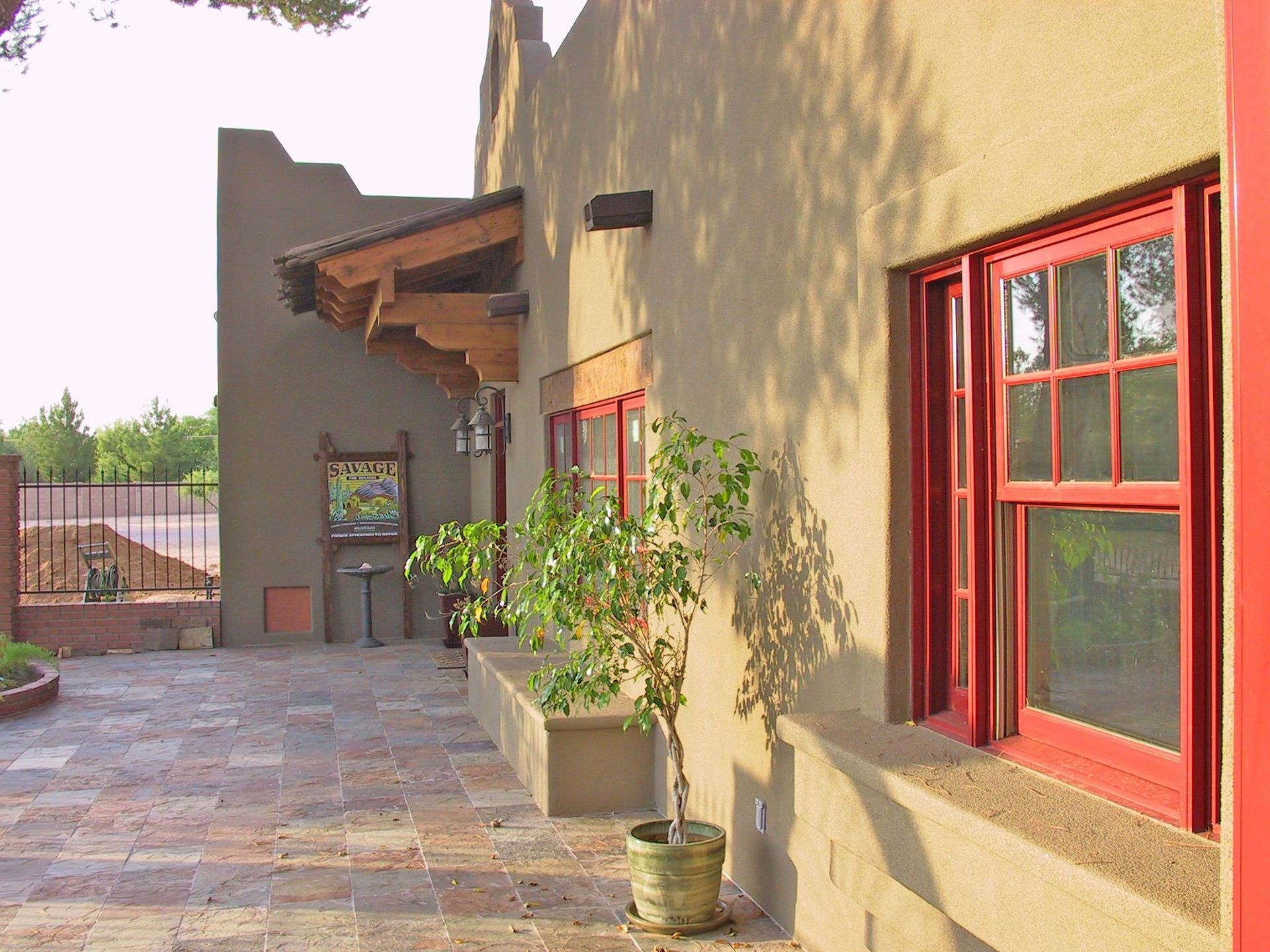 A stainless steel refrigerator is sitting on the floor in a kitchen.