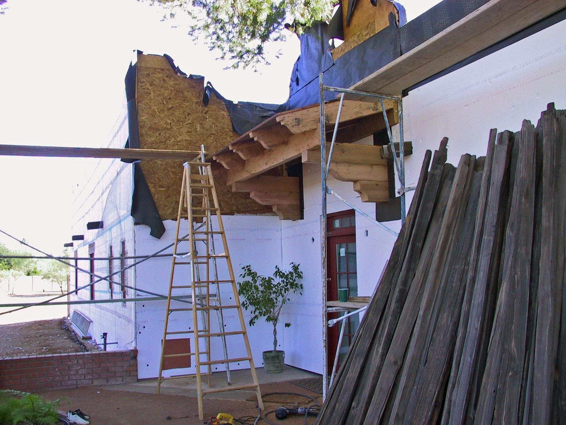 A ladder is sitting in front of a building under construction