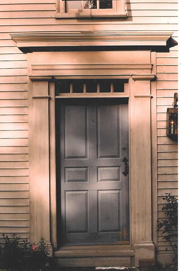 The front door of a house has a window above it