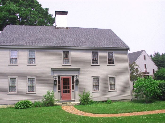 A house with a red door and a gray roof