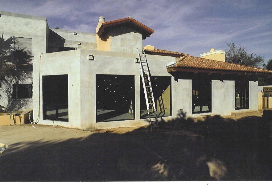 A picture of a house under construction with a ladder in front of it
