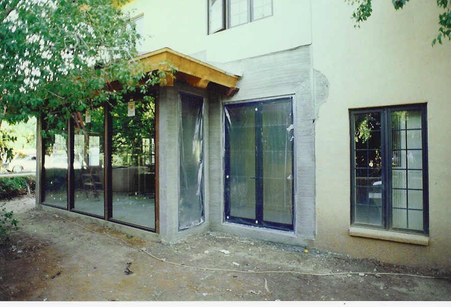 A house with a lot of windows and sliding glass doors