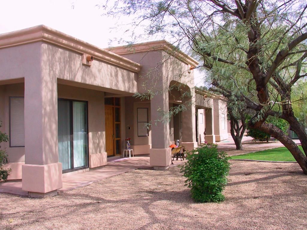 A house with a patio and trees in front of it