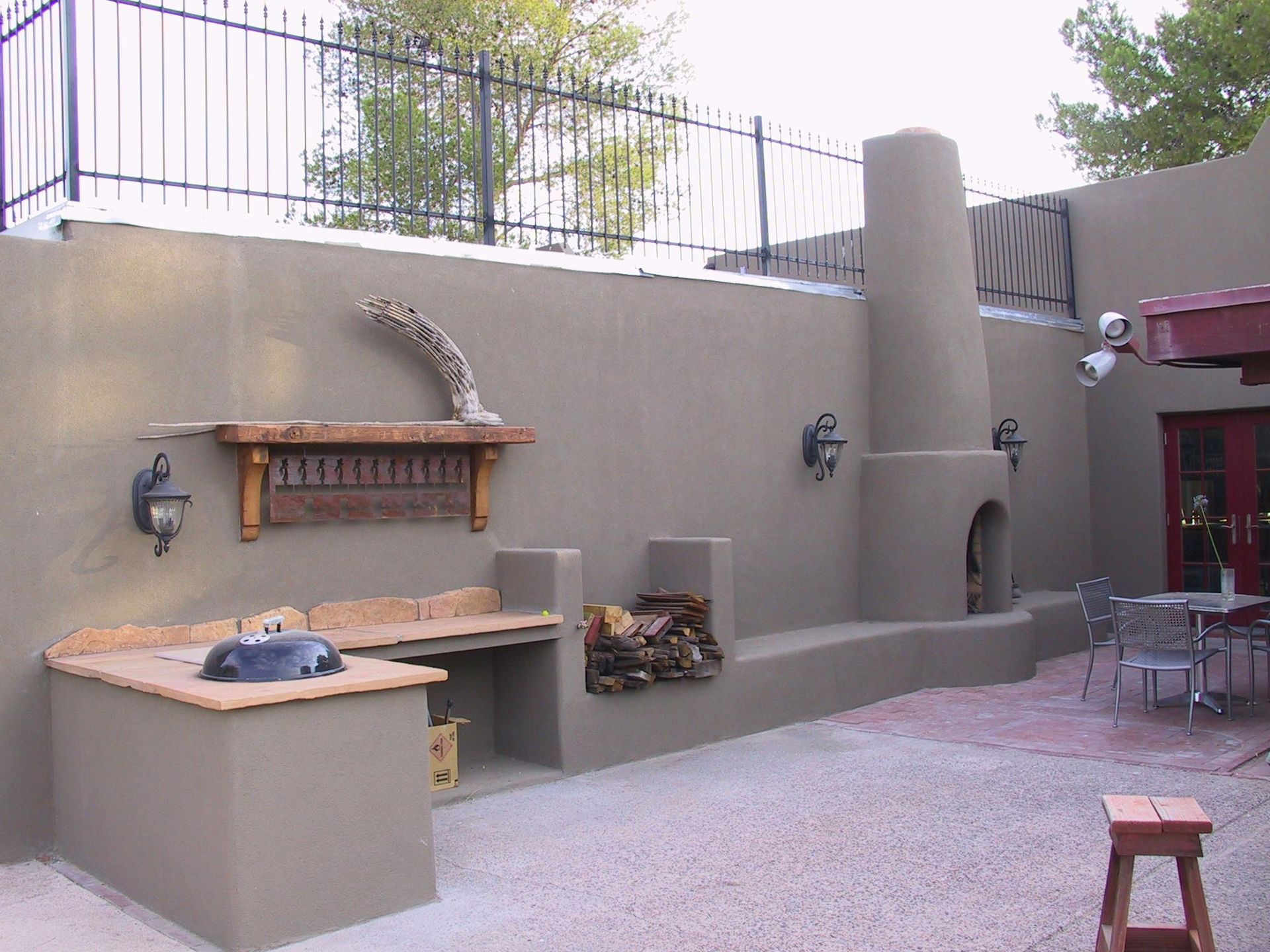 A patio area with a fireplace and a grill