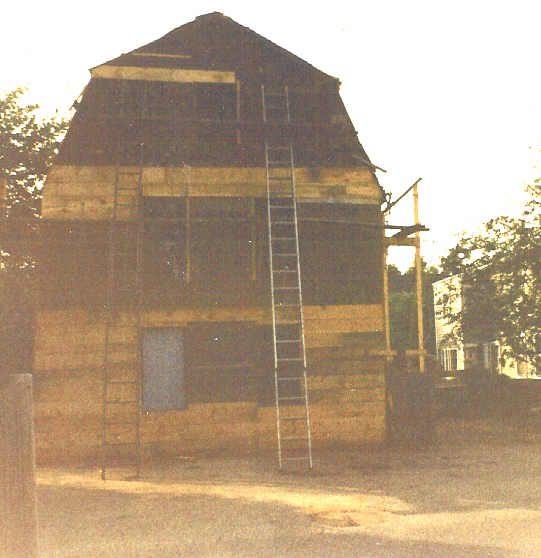 A wooden building with a ladder on the side of it