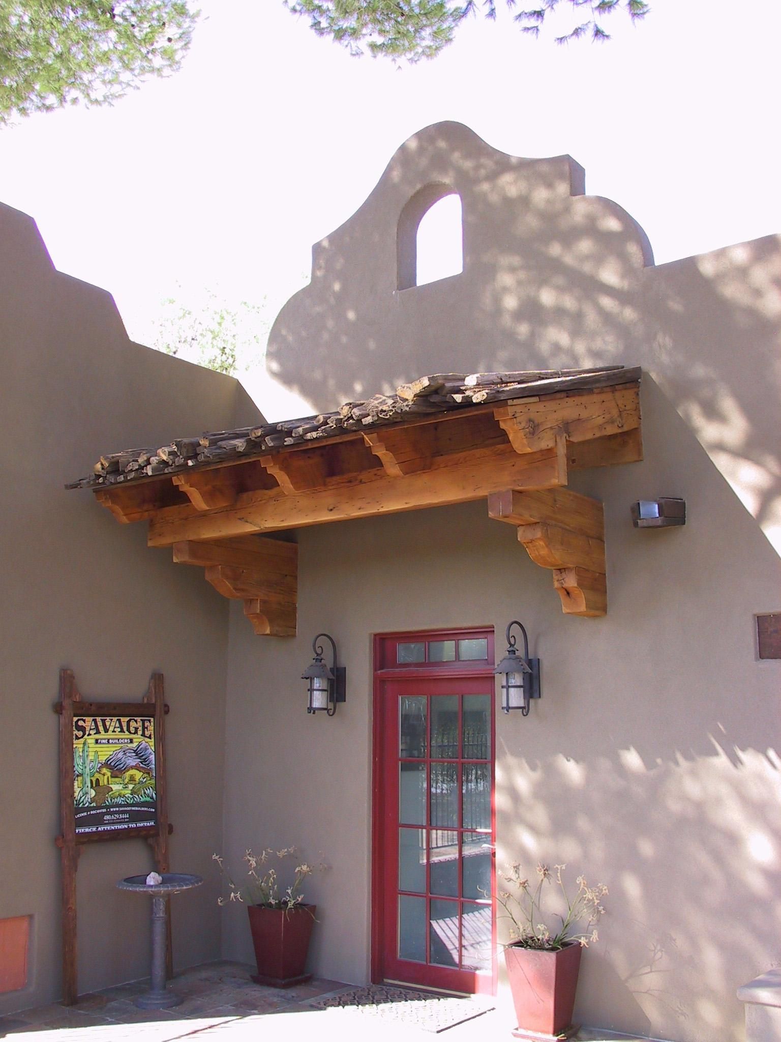 A building with a red door and a sign that says ' plaza ' on it