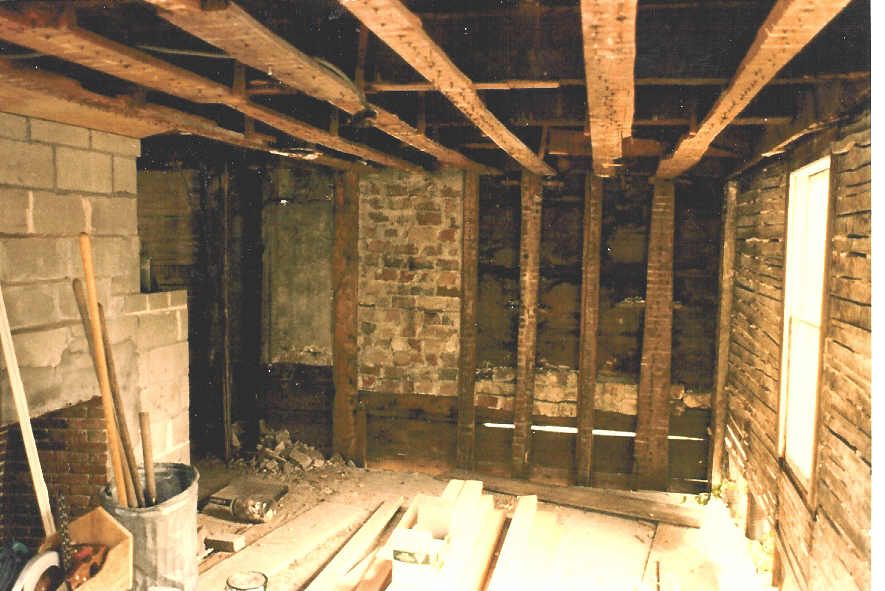A room with wooden beams and brick walls