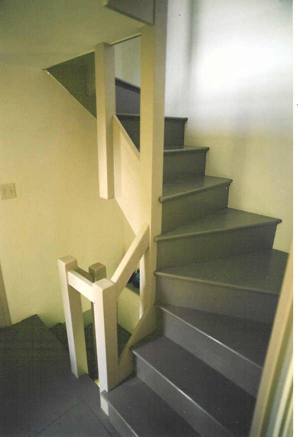A spiral staircase in a house with a white railing