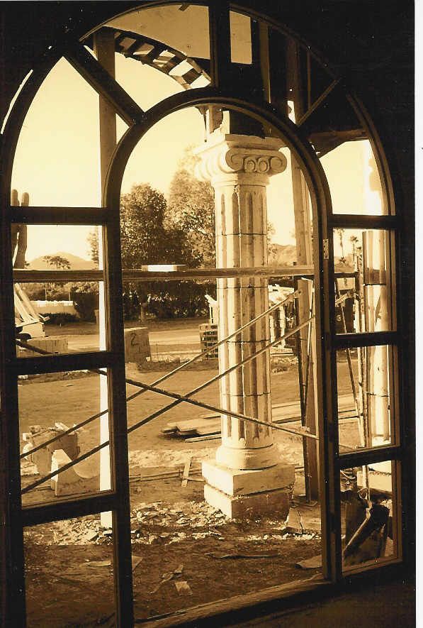 A black and white photo of a building under construction