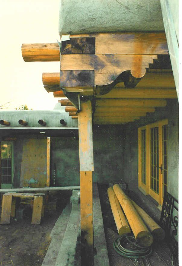 A picture of a house under construction with wooden beams