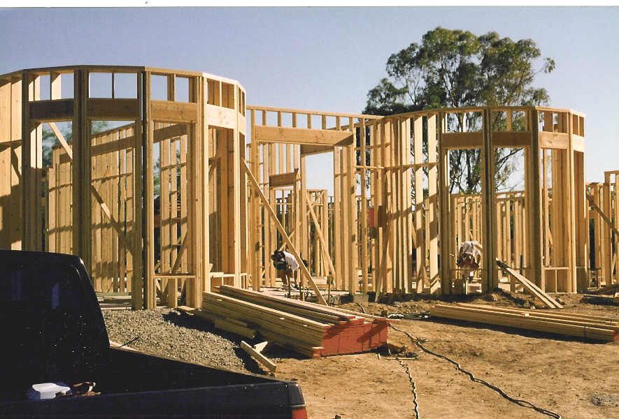 A truck is parked in front of a building under construction
