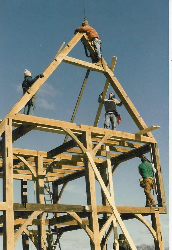 A group of men are working on a wooden structure