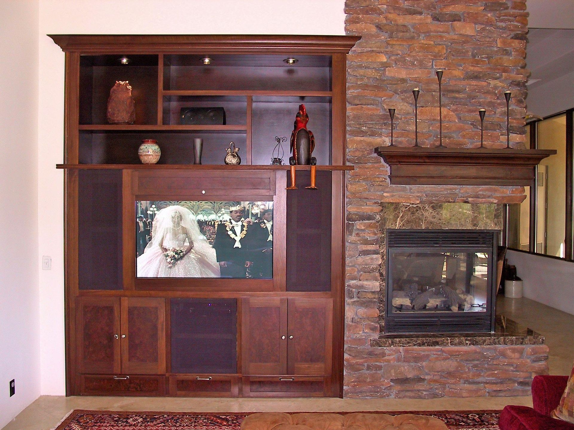 A living room with a fireplace and a flat screen tv