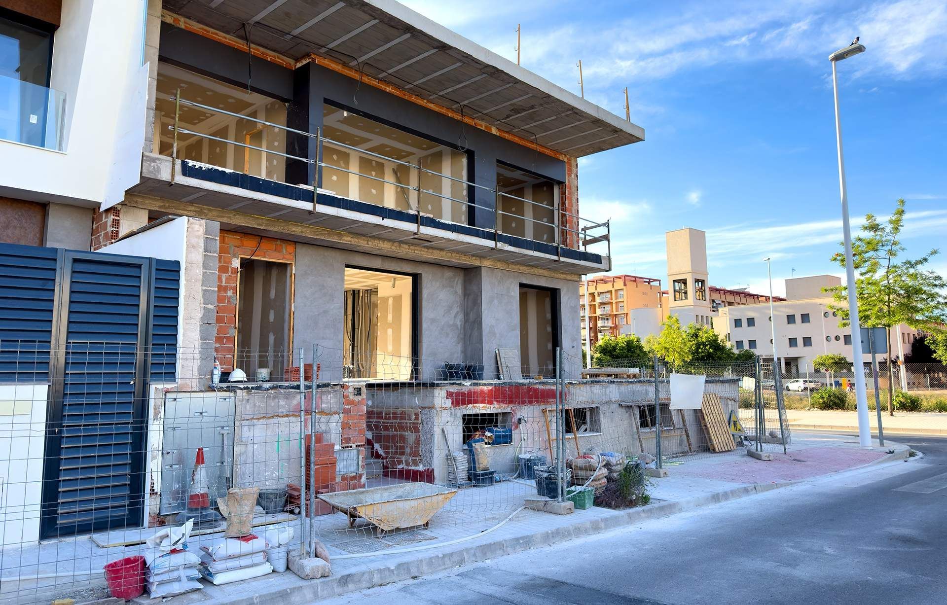 A large building is being built on the side of the road.