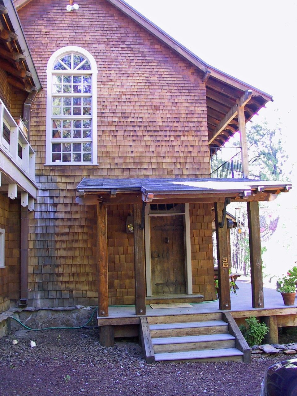 A brick building with a porch and stairs