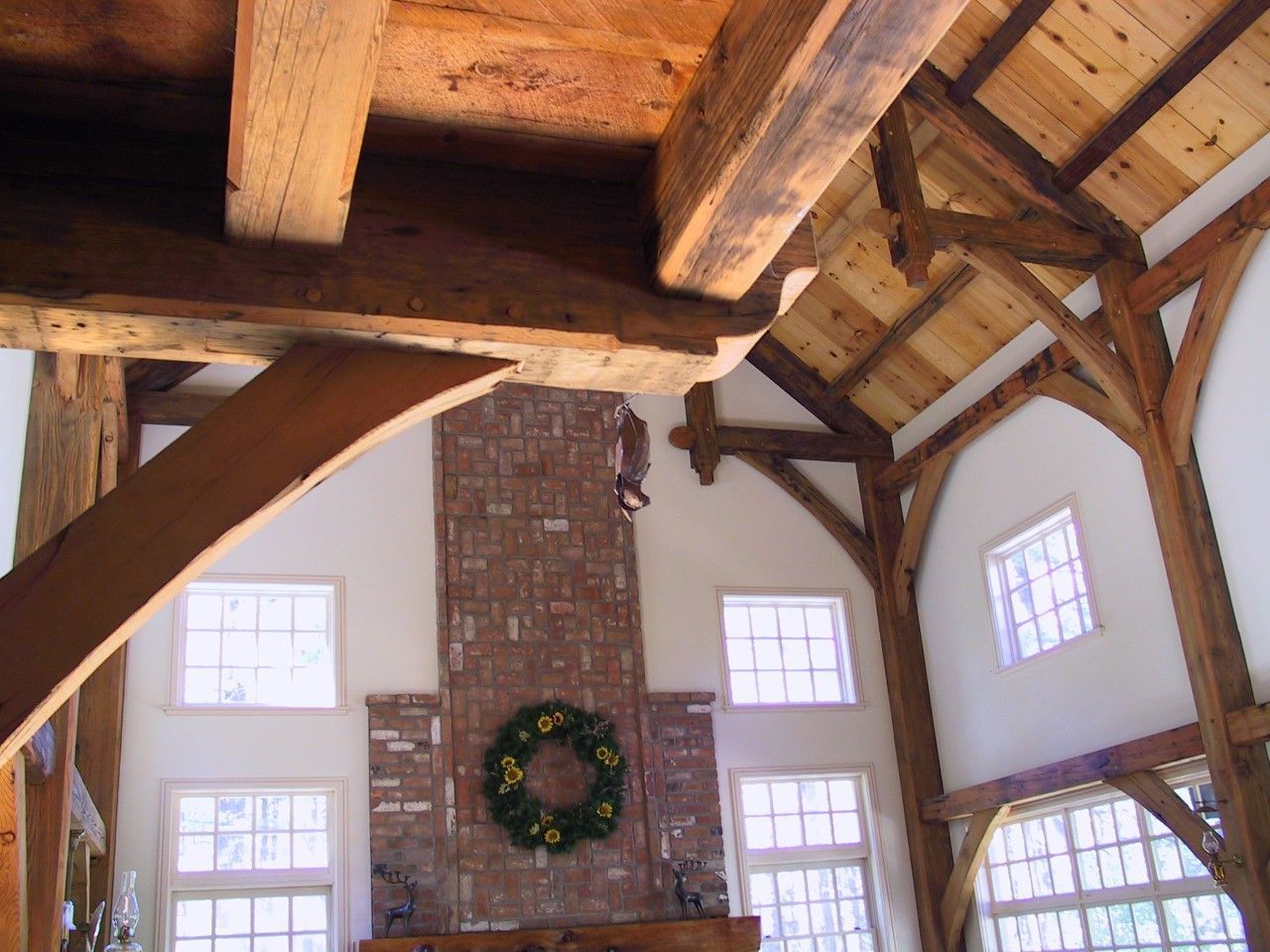 A brick fireplace with a christmas wreath on it