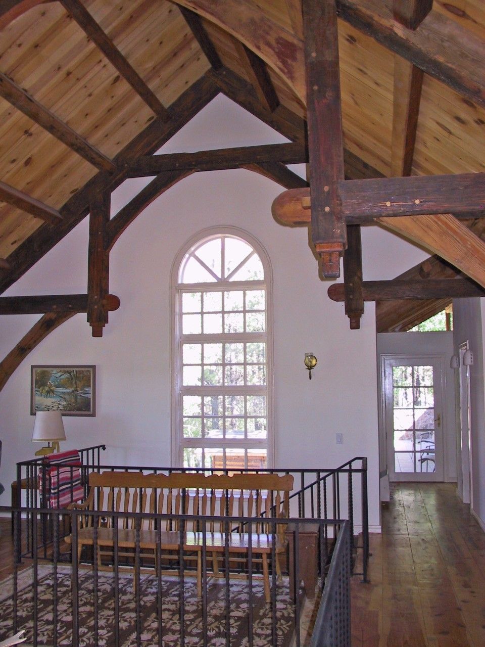 A living room with a wooden ceiling and a large window
