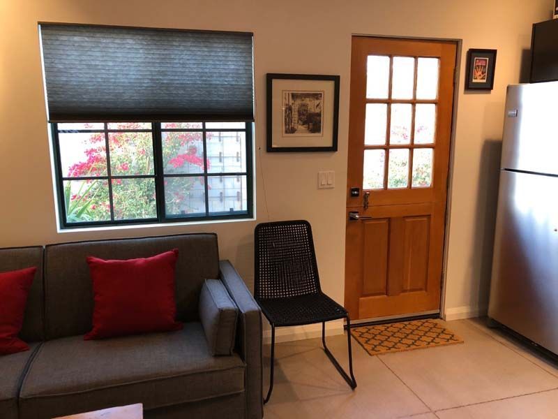 A living room with a couch a chair and a door