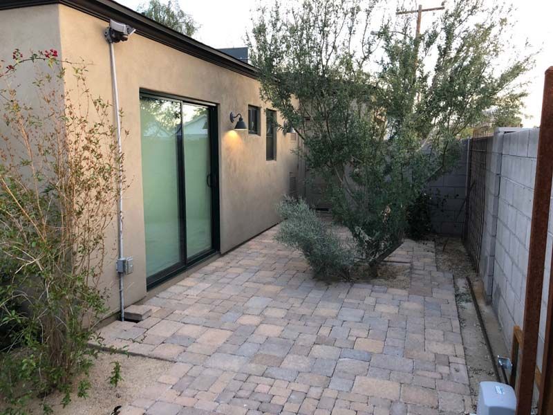 A house with a patio and a tree in front of it