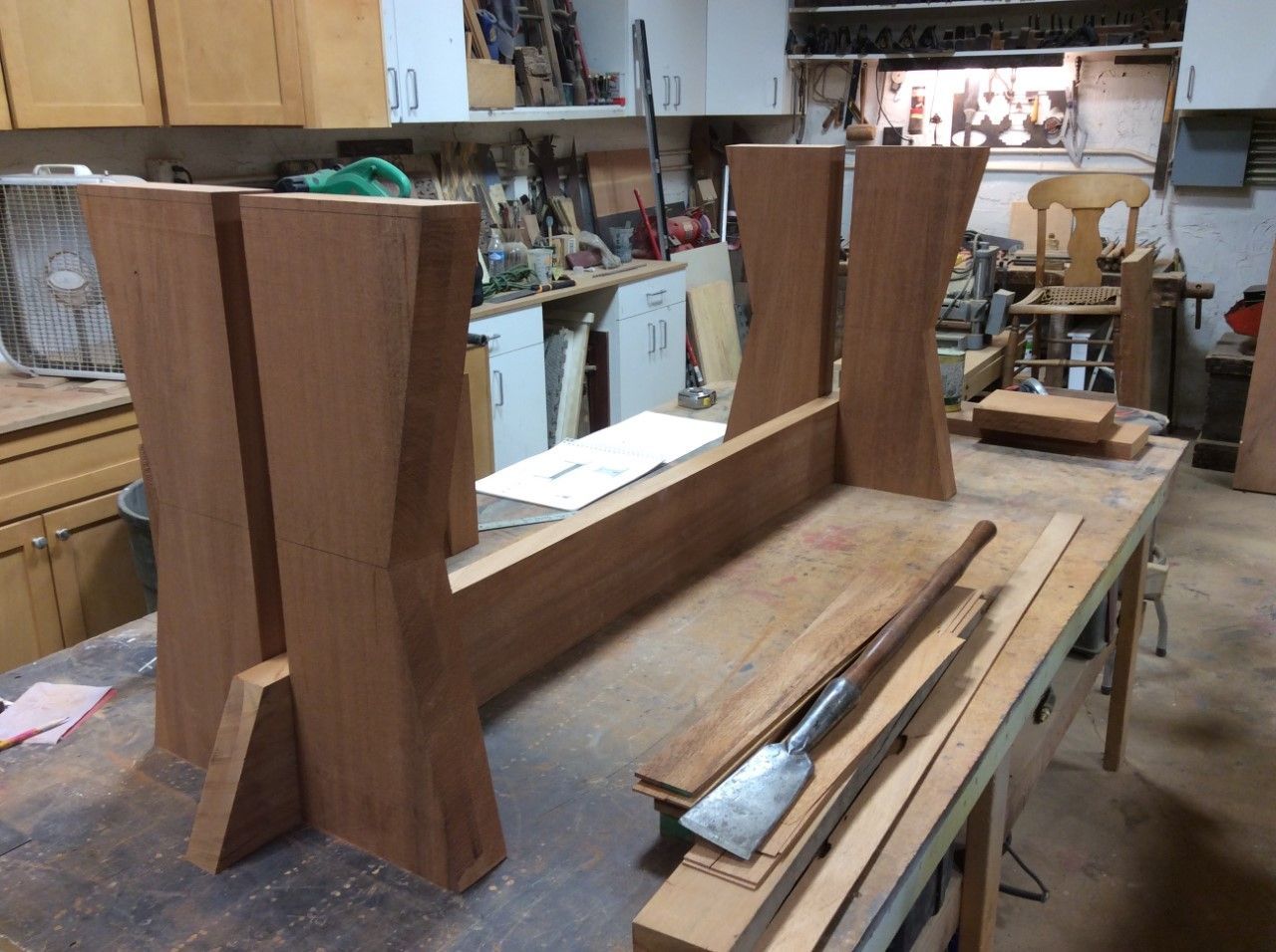 A wooden table is being built in a workshop