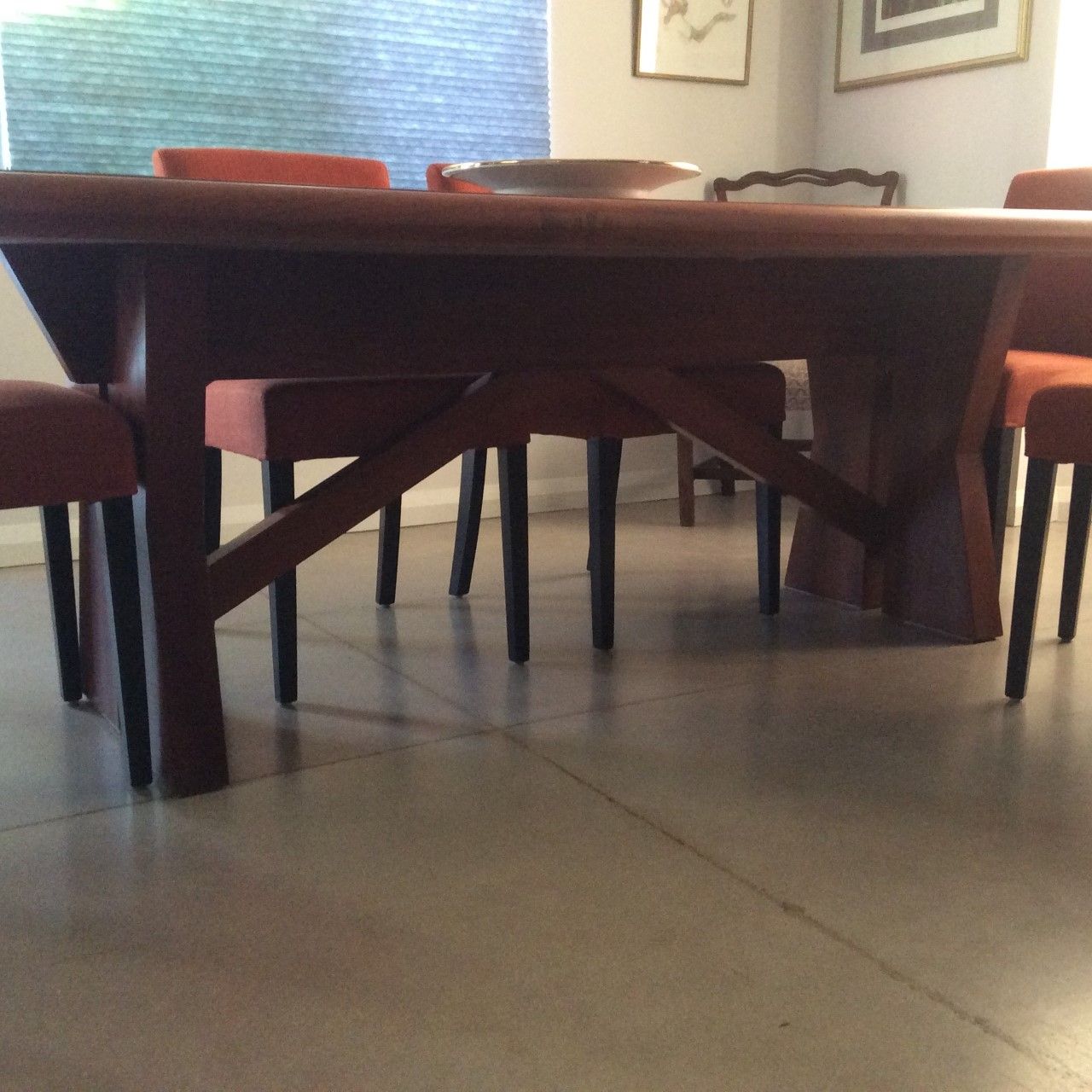 A wooden table and chairs in a dining room
