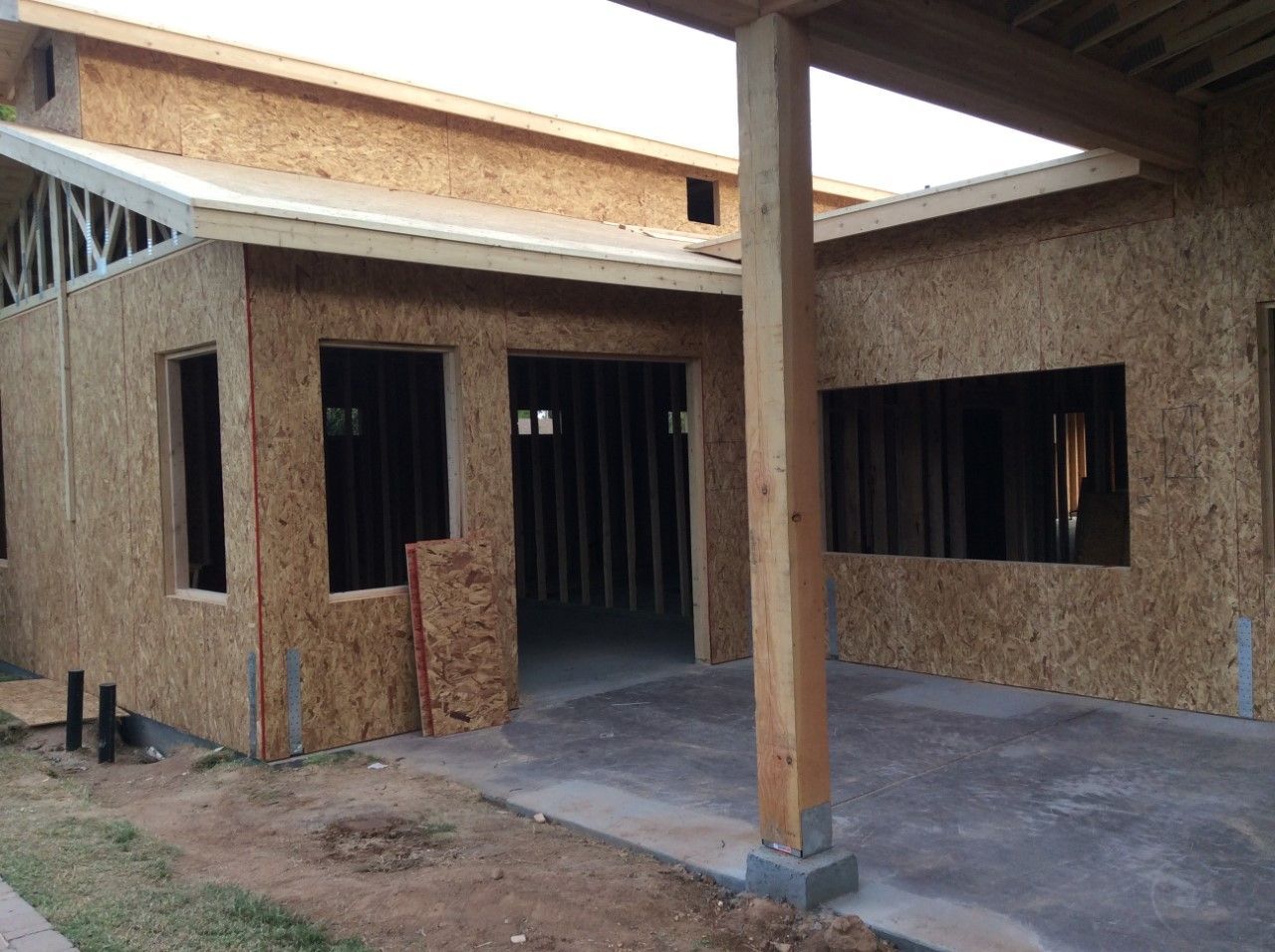 A house that is being built with a lot of windows