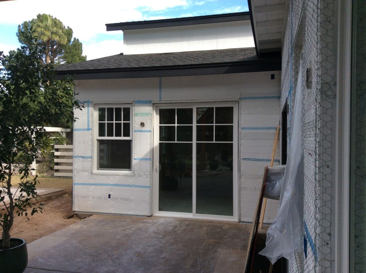 A white house with a sliding glass door and a window