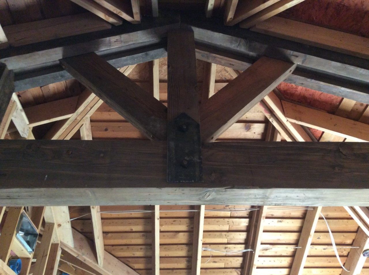 The ceiling of a building is made of wooden beams.