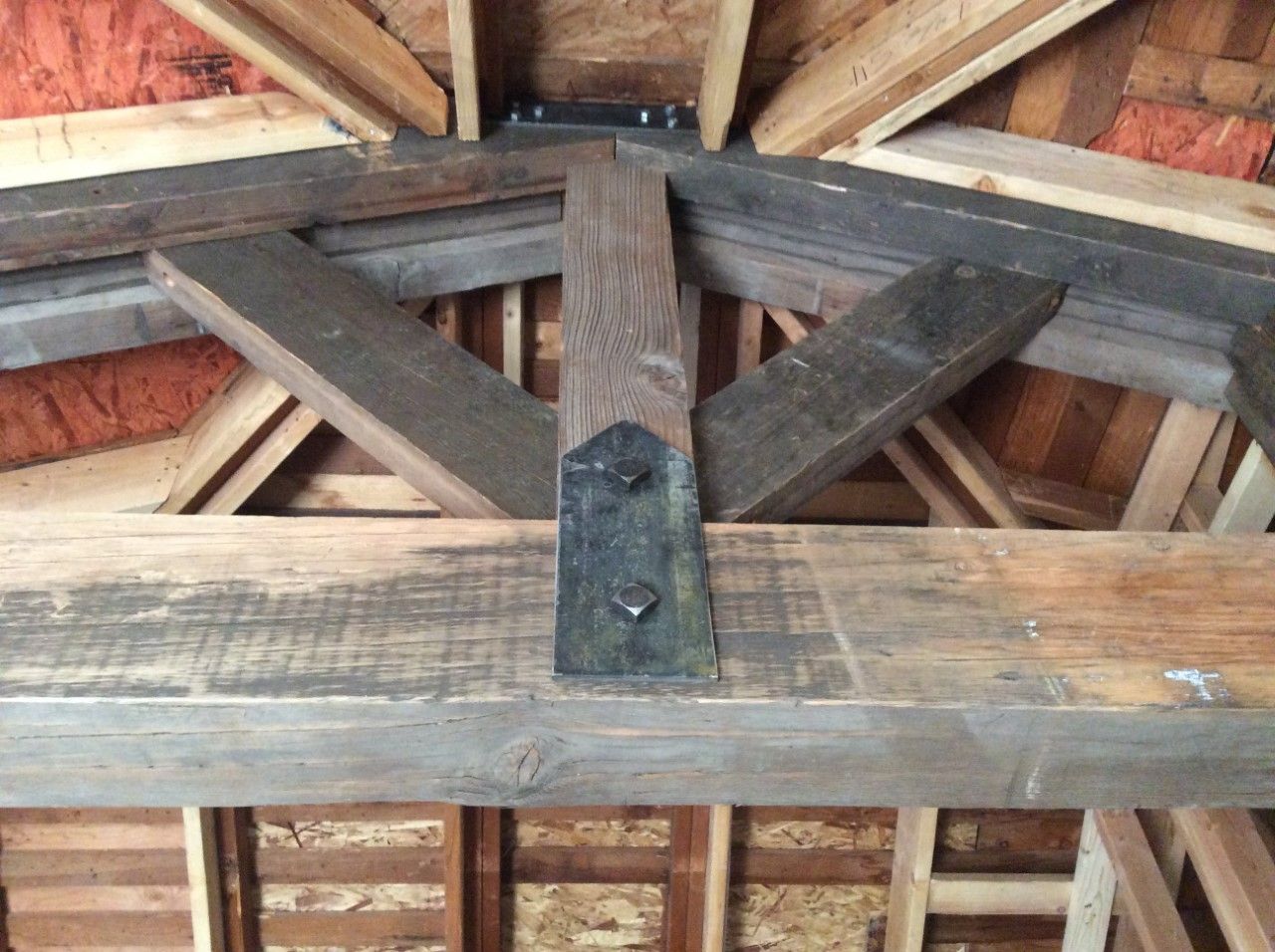 A wooden structure with a metal bracket attached to it