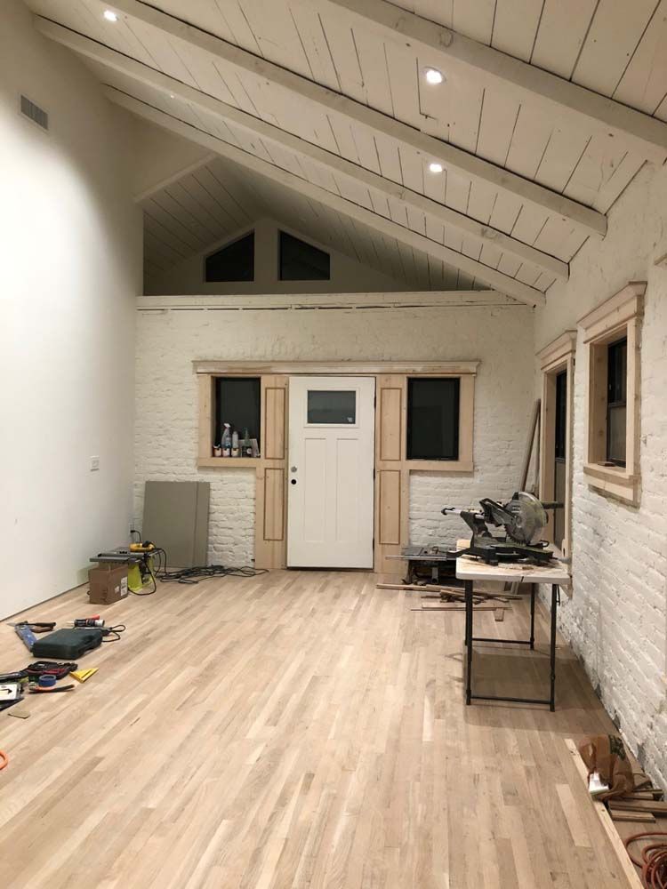 A room with hardwood floors and a white door