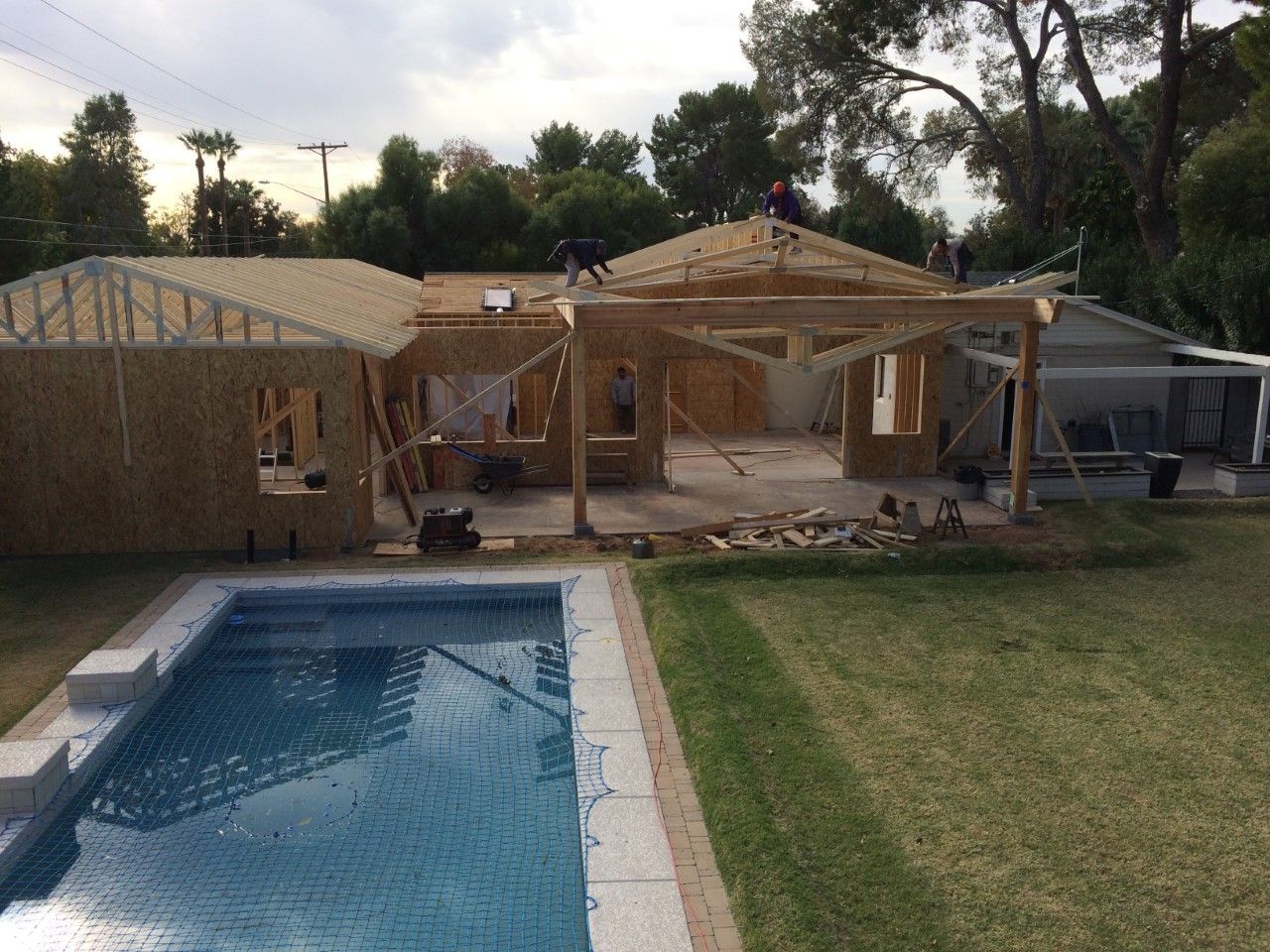 House under construction with swimming pool in yard.