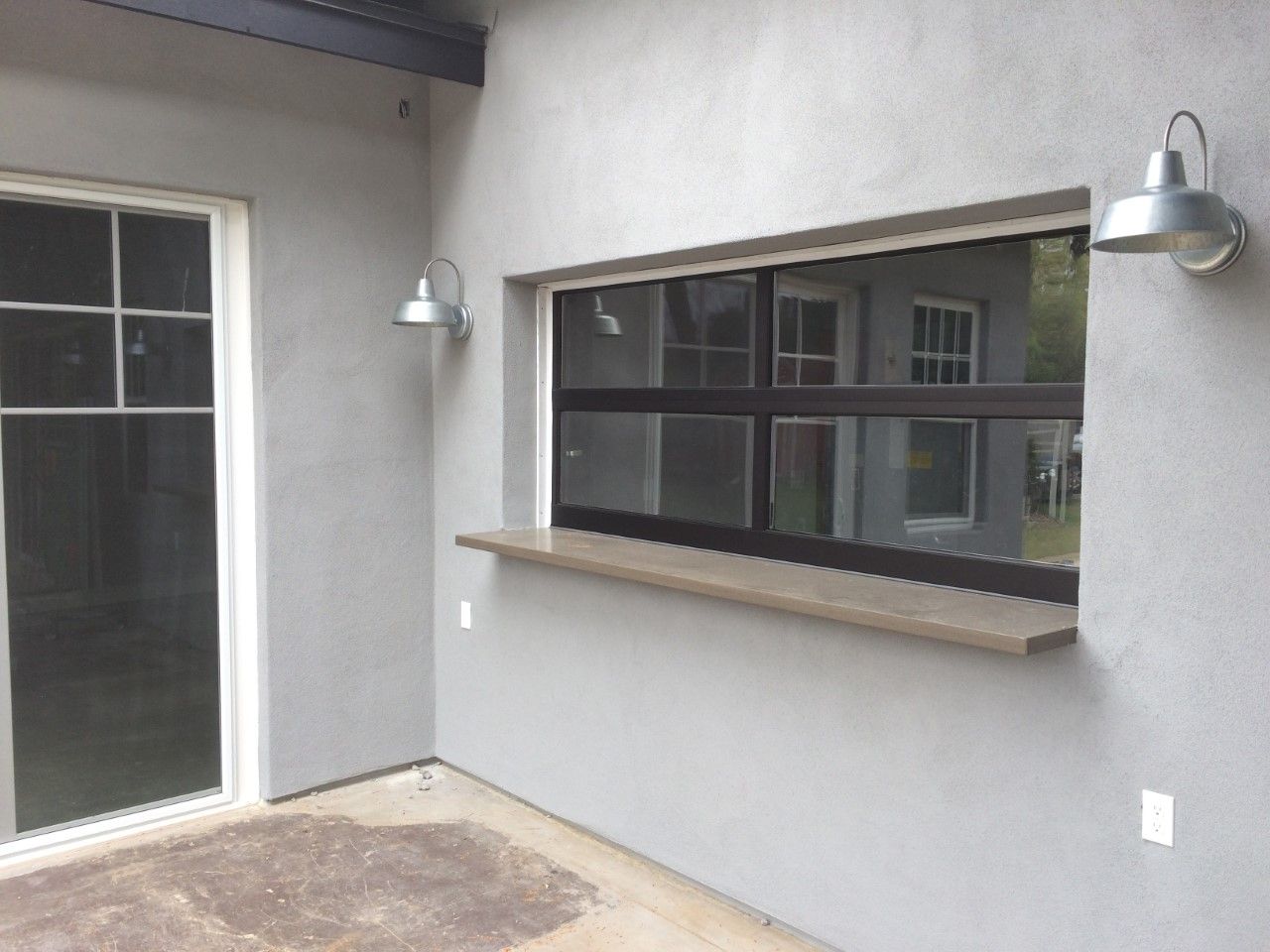 A wall with a window and a light on it