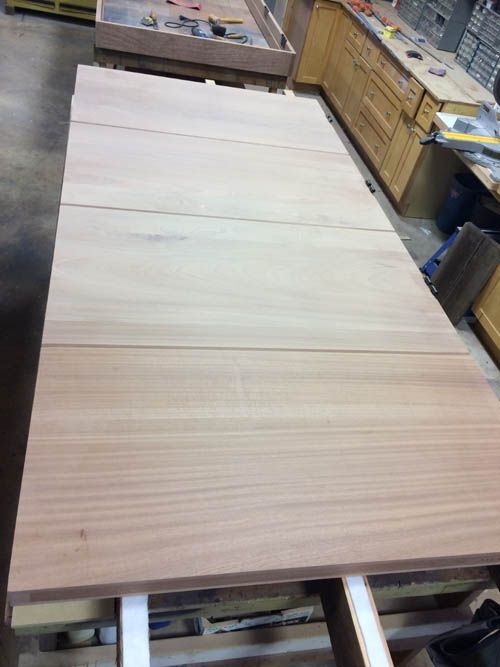 A large piece of wood is sitting on top of a table in a workshop.