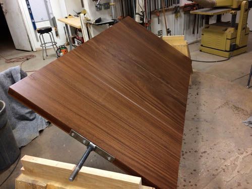 A wooden table is sitting on top of a wooden table in a workshop.