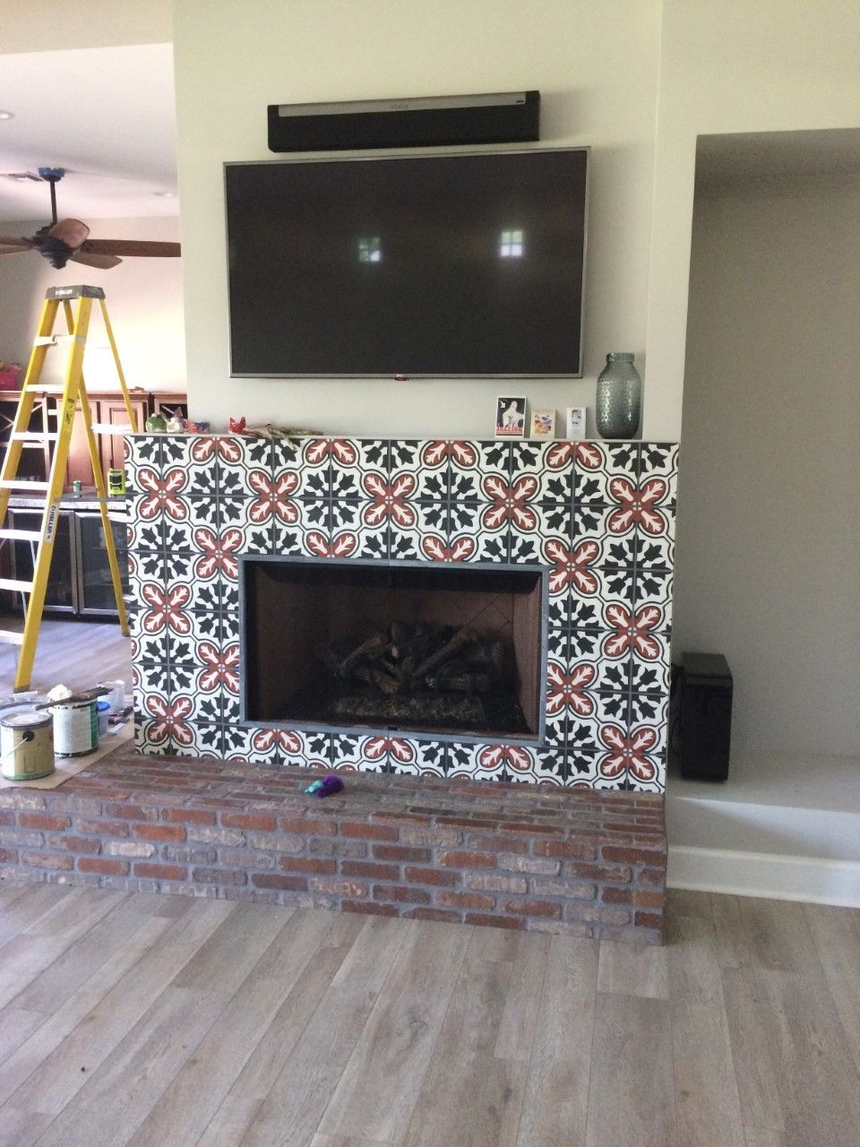A living room with a fireplace and a flat screen tv
