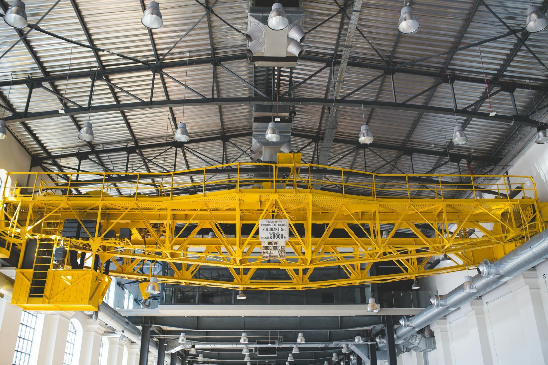 Yellow overhead crane inside a building.