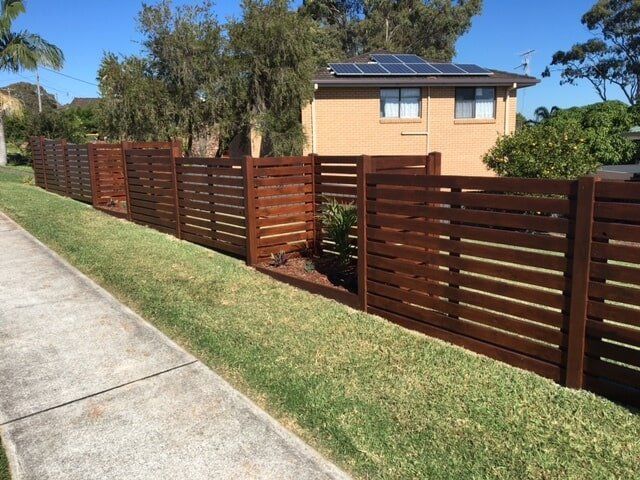 Wooden Fence with Curved on the Plants — Fencing in Port Macquarie, NSW