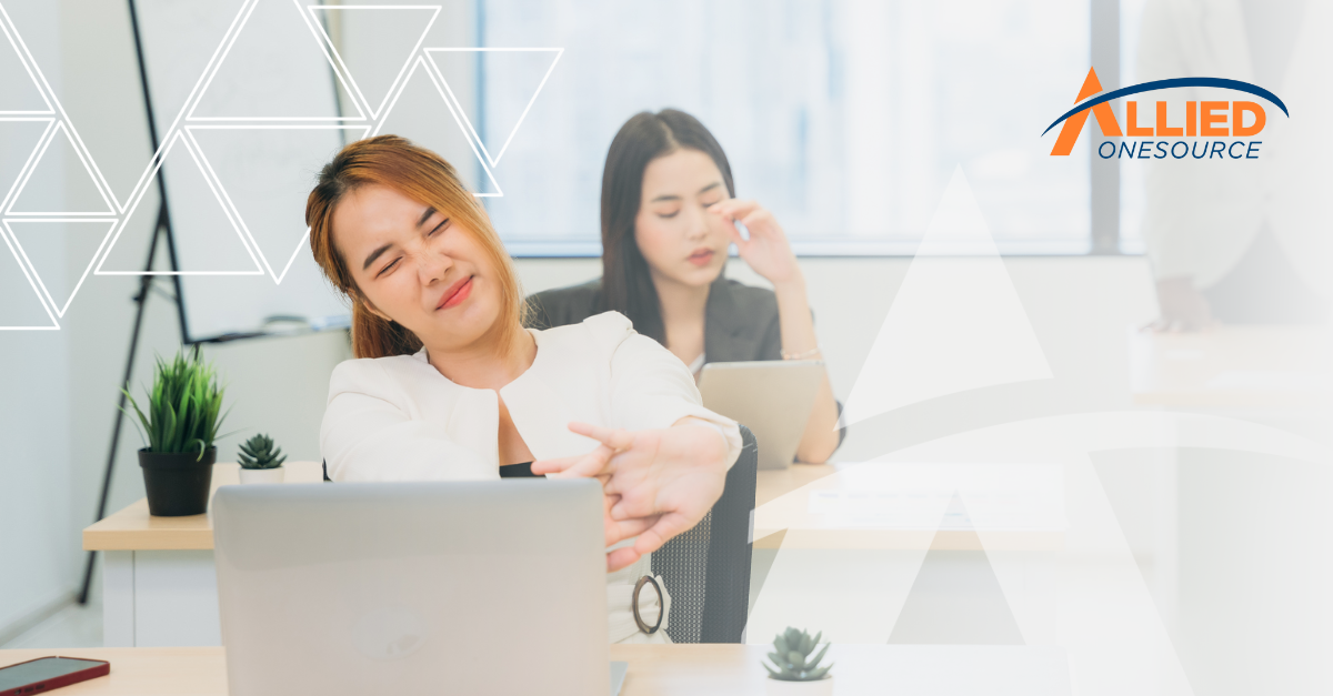 Office worker showing signs of stress while managing employee burnout during busy holiday work perio