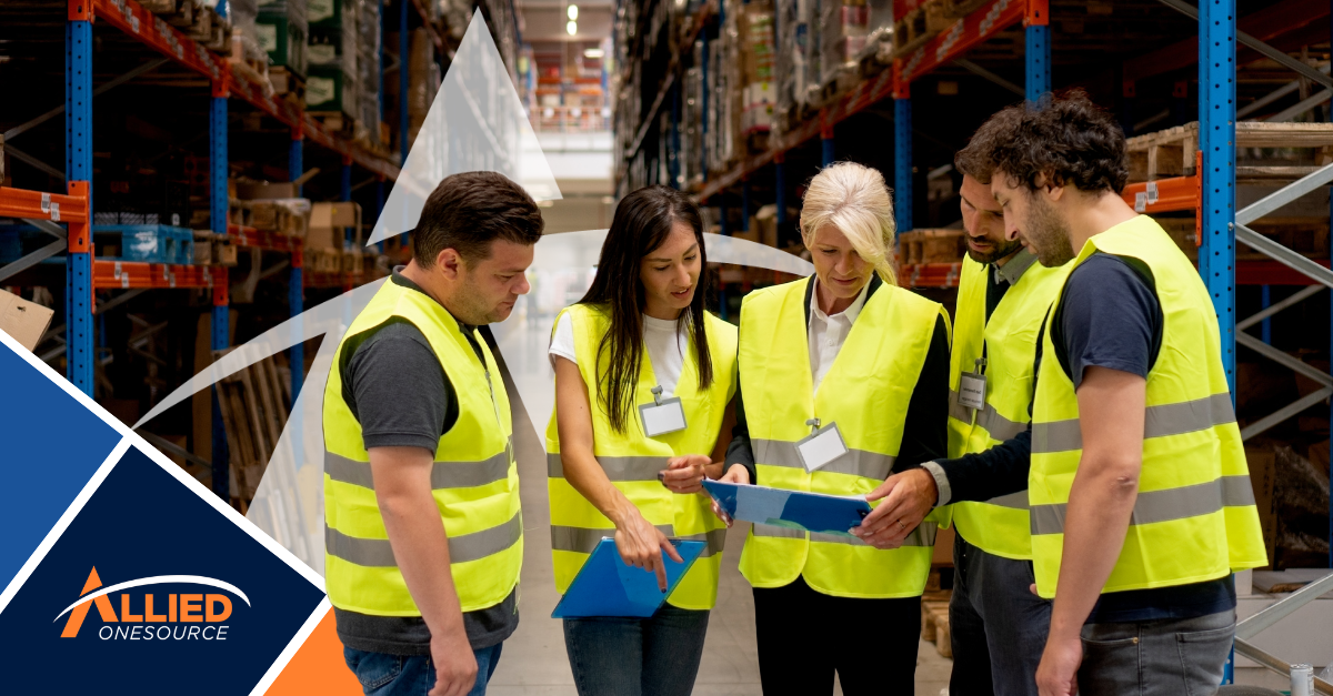 Warehouse team in safety vests discussing career paths in distribution and logistics leadership 