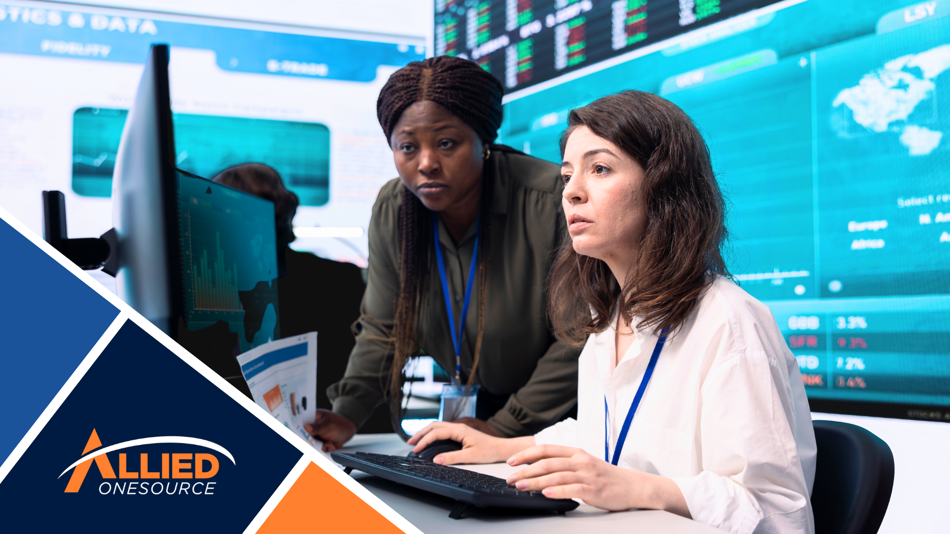 Two women analyze data on screens, spotlighting women in skilled trades.