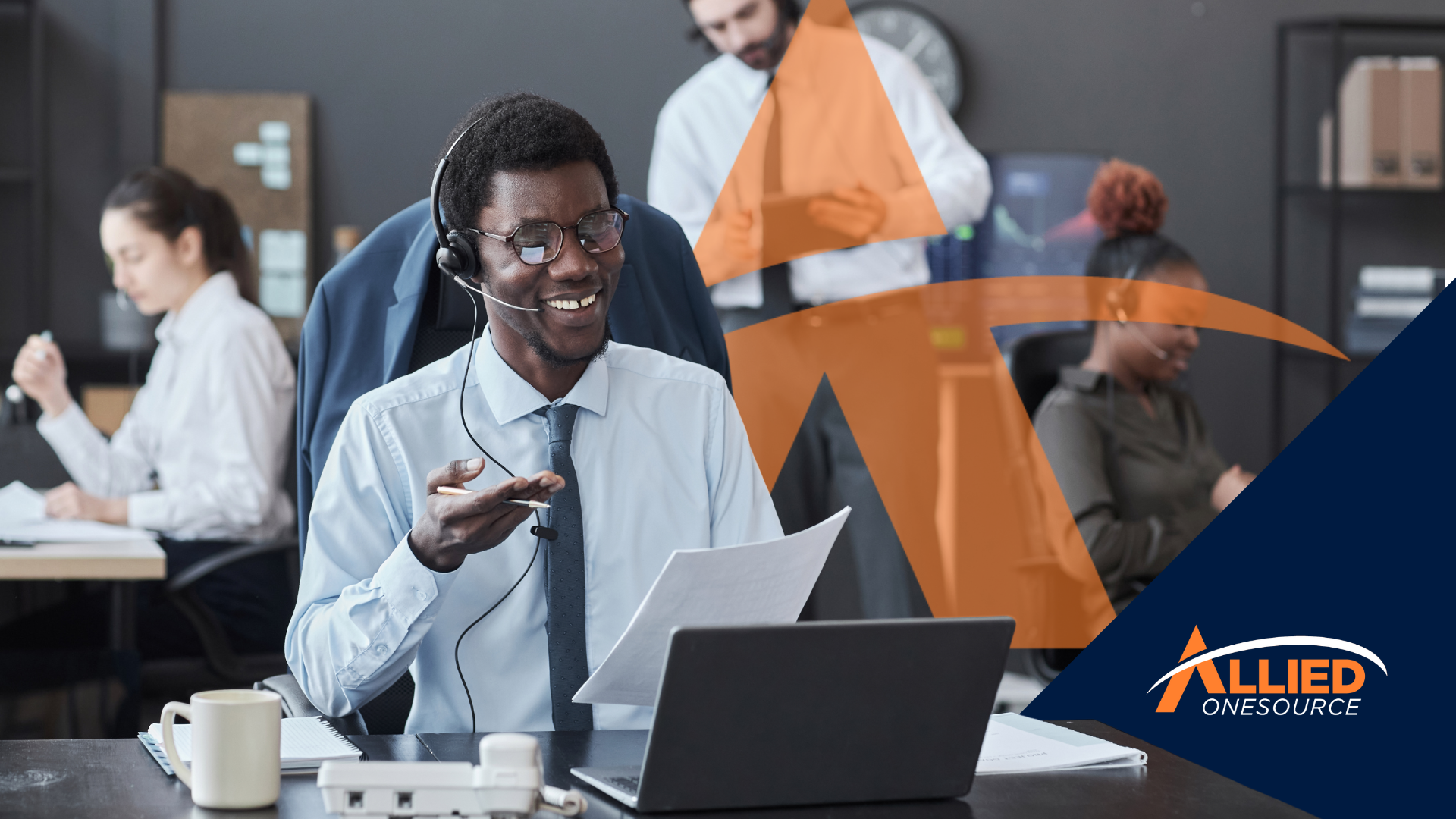 Smiling contact center representative with headset and laptop in modern office environment where hir