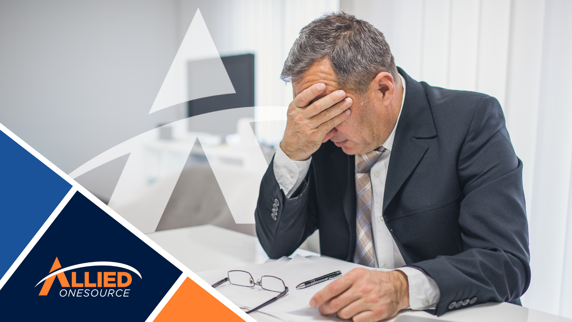 Stressed executive with head in hands showing Q4 hiring delays impact on business productivity