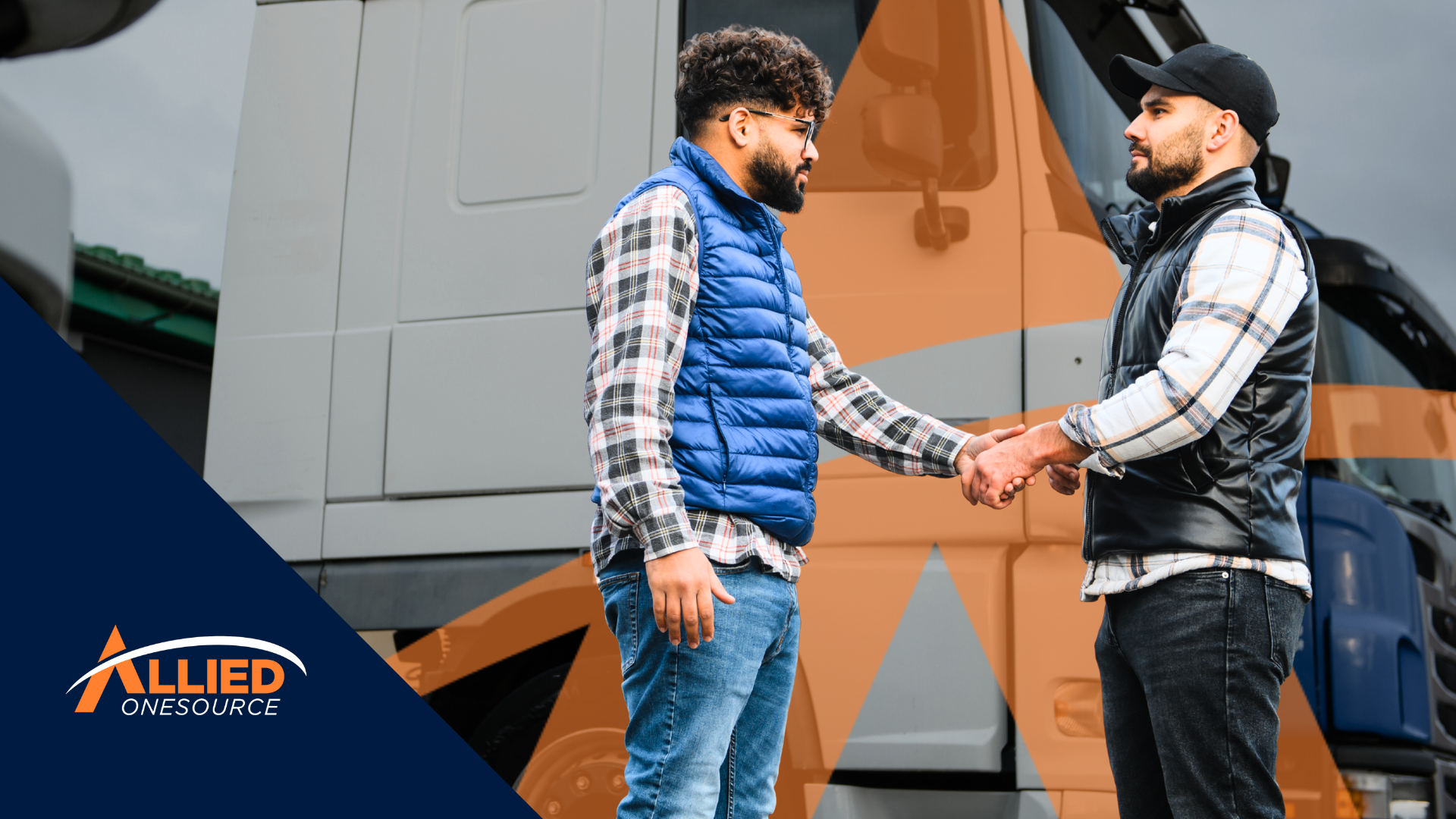 Two logistics workers shake hands in front of commercial trucks, reflecting logistics salary trends 