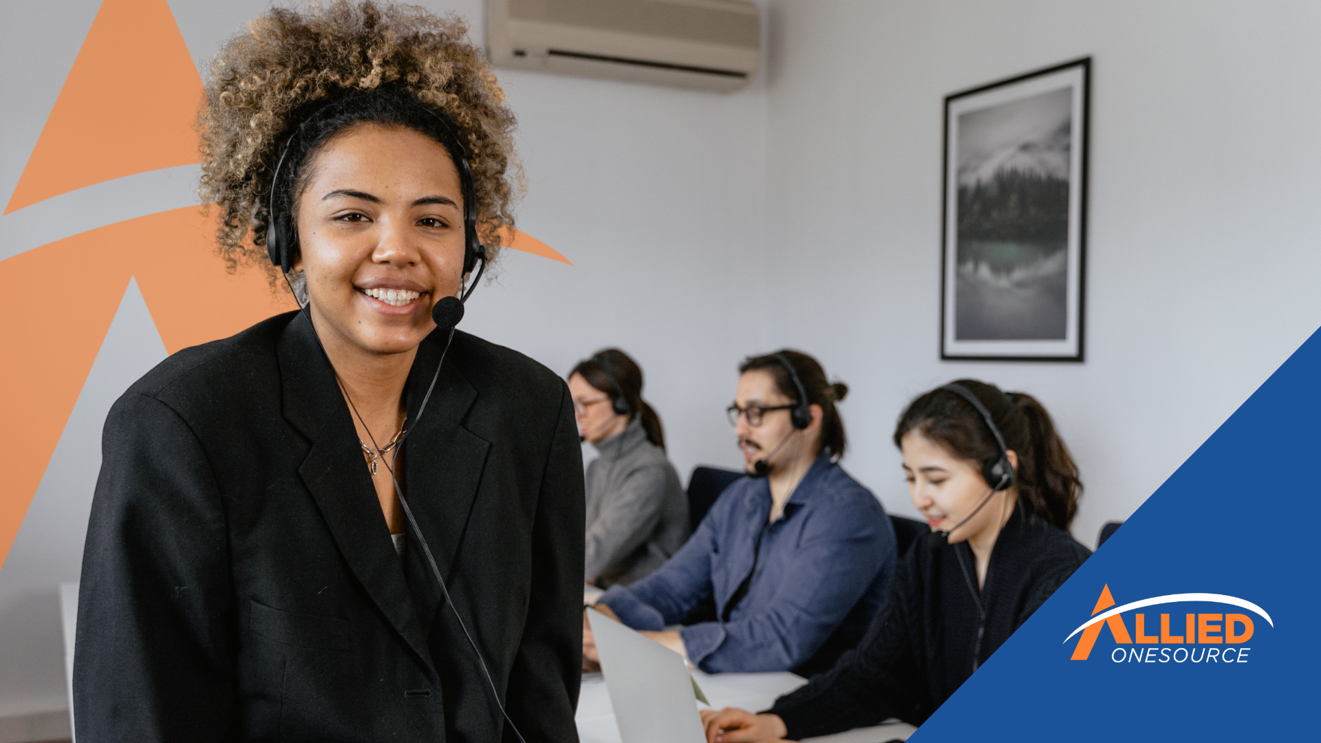 A team of call center employees wearing headsets works at desks in an office, focusing on customer e