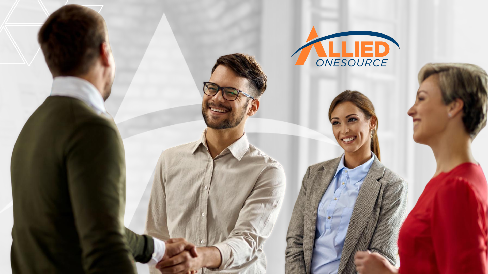 Two business professionals shaking hands in office representing successful staffing partnerships
