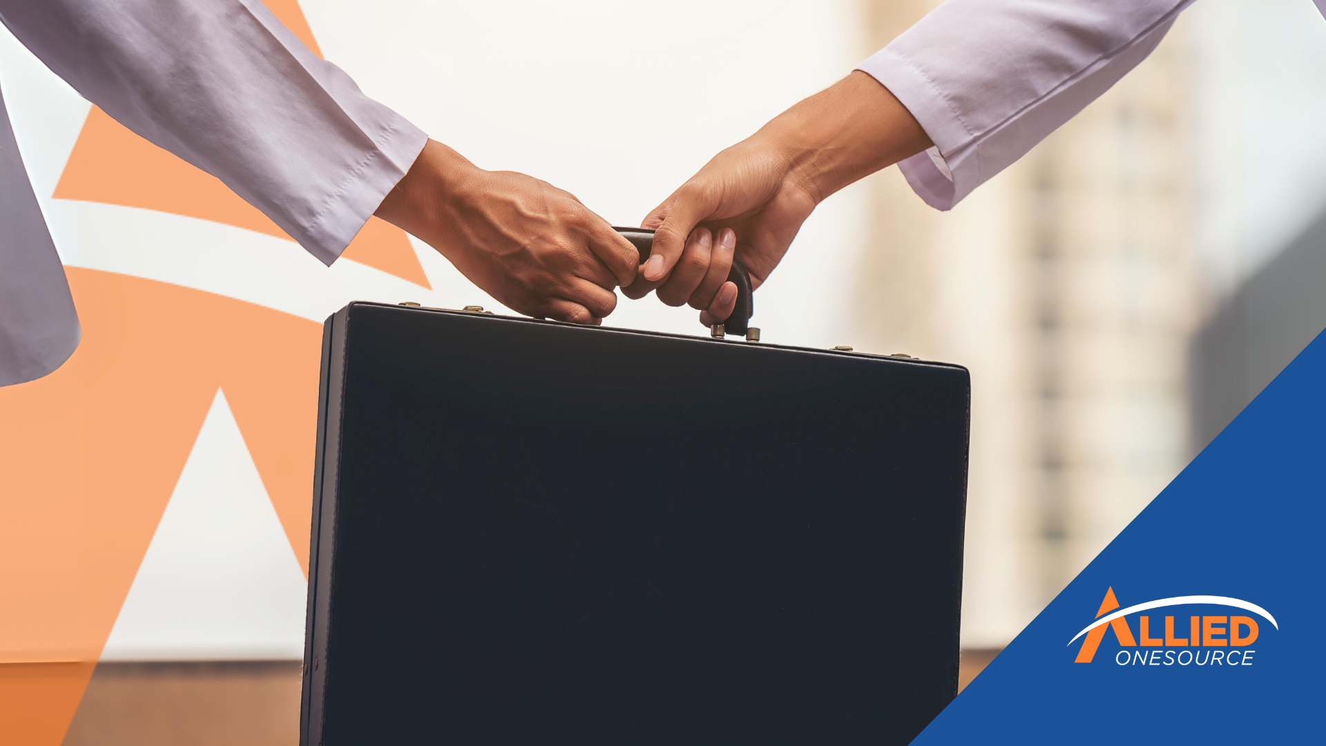 two people holding a briefcase in their hands.