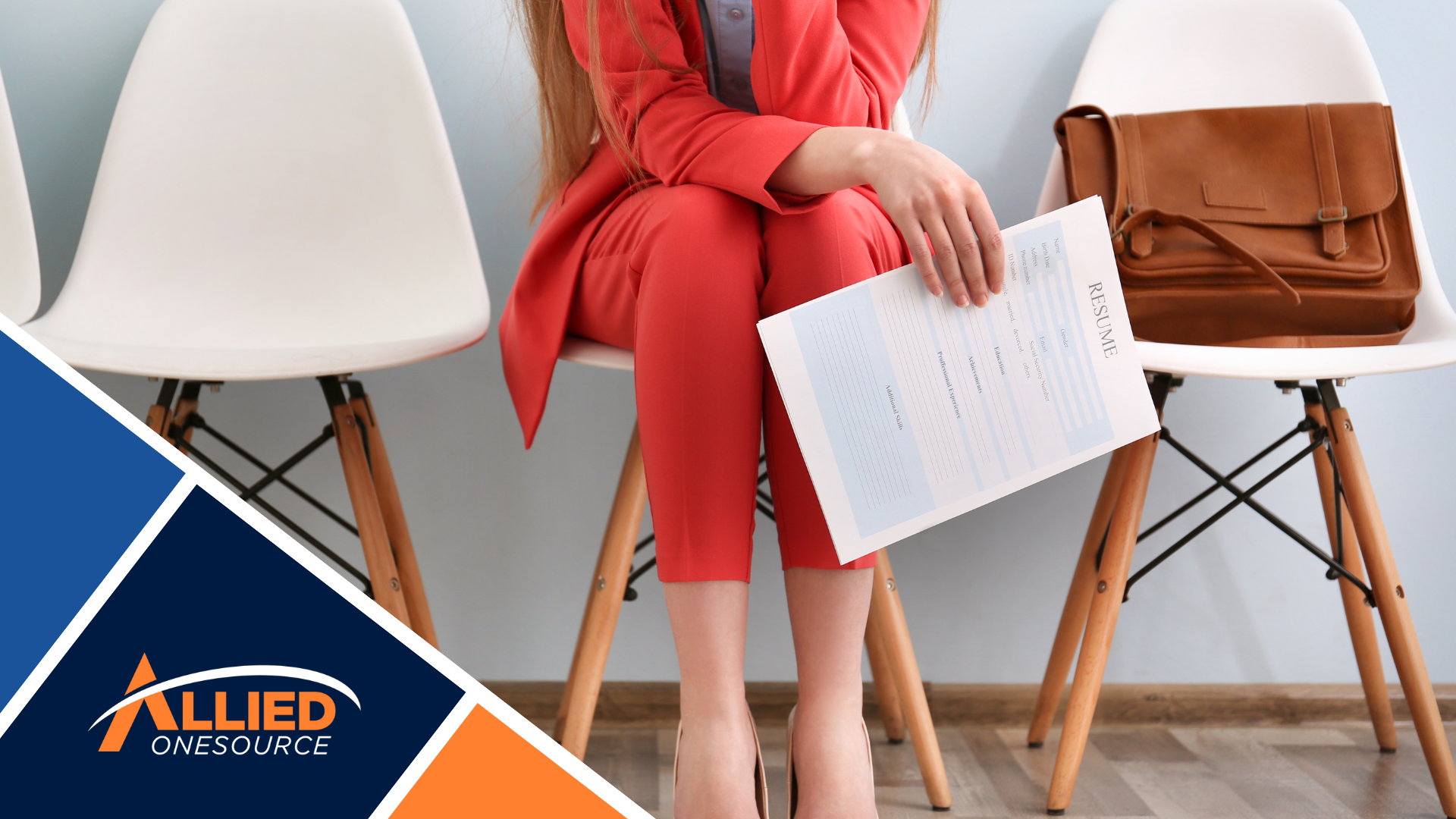 A woman sitting on a chair holding a piece of paper.